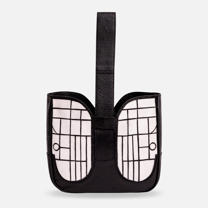 Black and white leather handbag with geometric grid pattern and top handle