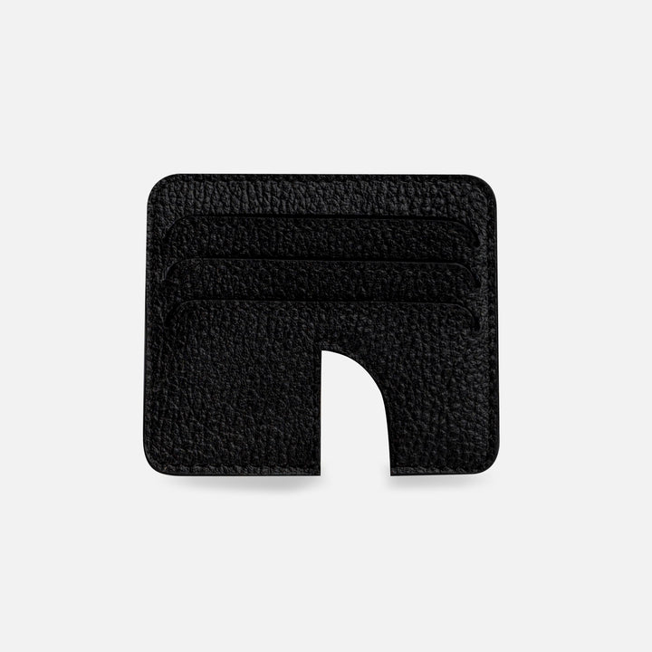 Minimalist black leather card holder with four slots and curved cutout on white background