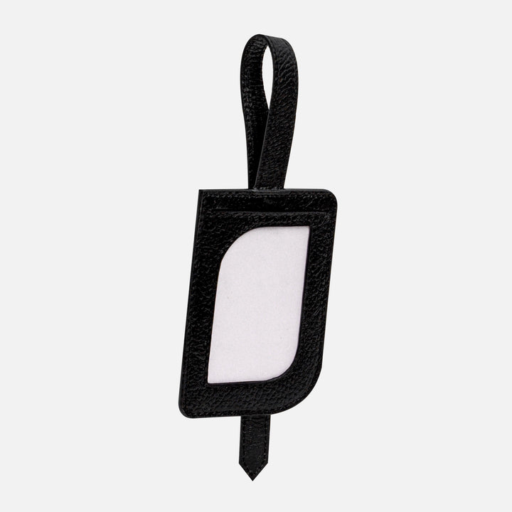 Black leather luggage tag with loop and clear ID window isolated on white background