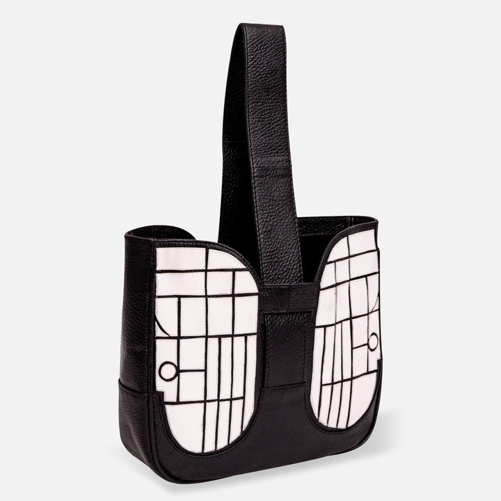 Black leather handbag with wide handle and white geometric pattern on front