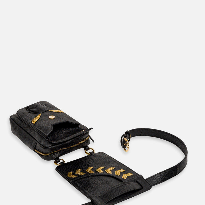 Black leather belt bag with gold chevron studs and heart design on white background
