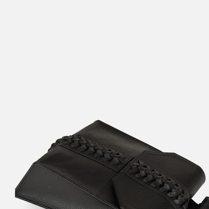 Black leather clutch bag with intricate braided detail on flap against white background