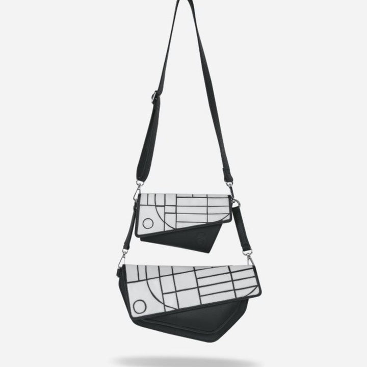 Two black and white crossbody bags with geometric patterns and detachable straps on white background