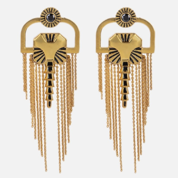 Pair of gold metal earrings with black enamel accents and gold chain fringes on white background