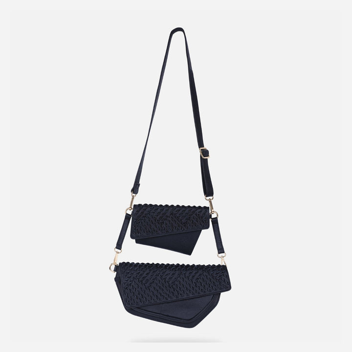 Black leather upcycled woven crossbody bag with detachable belt on white background