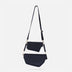 Black leather upcycled woven crossbody bag with detachable belt on white background