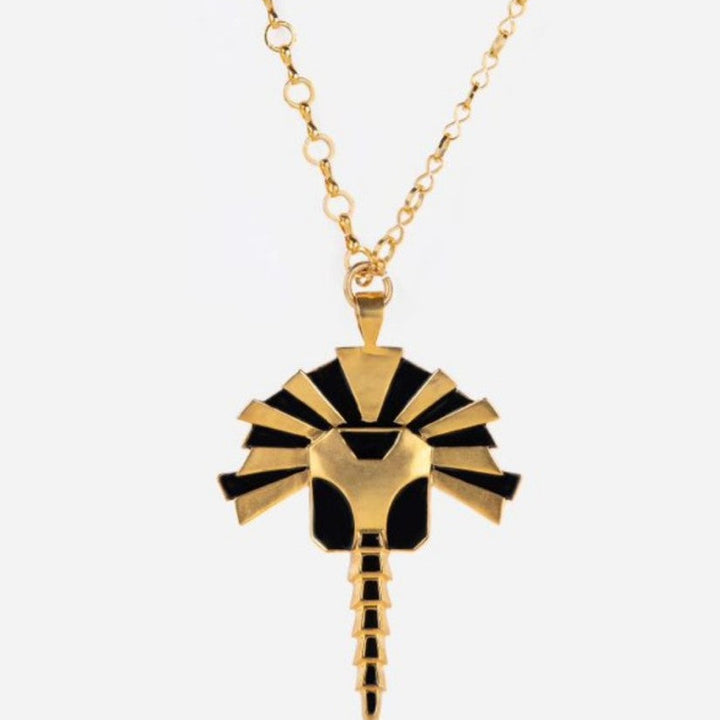 Gold and black enamel metal pendant necklace with an abstract tribal design and adjustable gold chain