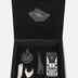 Open black leather gift box with upcycled handcrafted accessories including keychains and a pouch