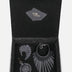 Open black gift box containing upcycled black leather jewelry and accessories by Econock