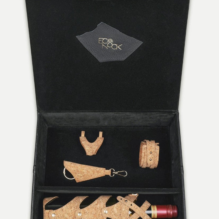 Econock black gift box containing tan upcycled leather wine bottle holder, bracelet, keychain, and accessory handmade in India