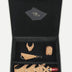 Econock black gift box containing tan upcycled leather wine bottle holder, bracelet, keychain, and accessory handmade in India