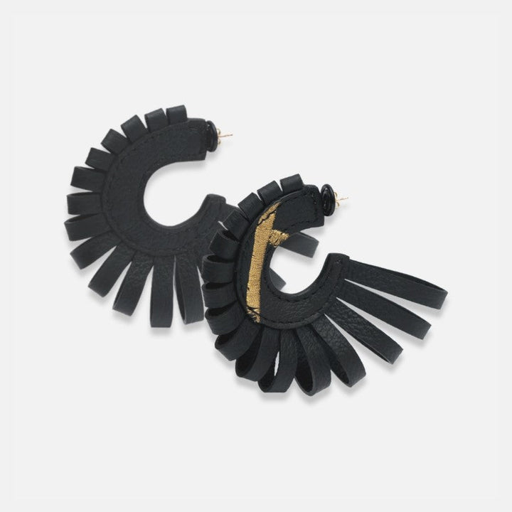 Handcrafted black leather hoop earrings with fringe and subtle gold accent on white background