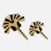 Two handcrafted gold and black enamel metal brooches in abstract zebra head design on white background