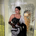 Woman in black embroidered blouse and white saree holding a modern black and white handbag at Indian couture event