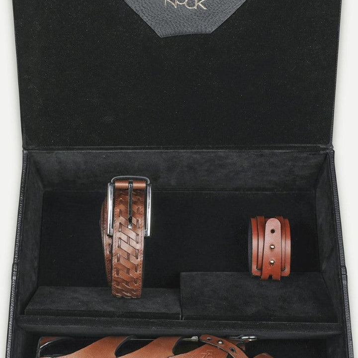 Black gift box with Eco Nook logo containing brown leather belt, bracelet, and leather-covered wine bottle