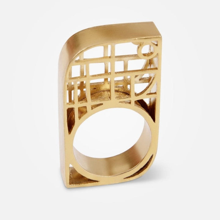 Modern geometric gold ring with open lattice design on white background