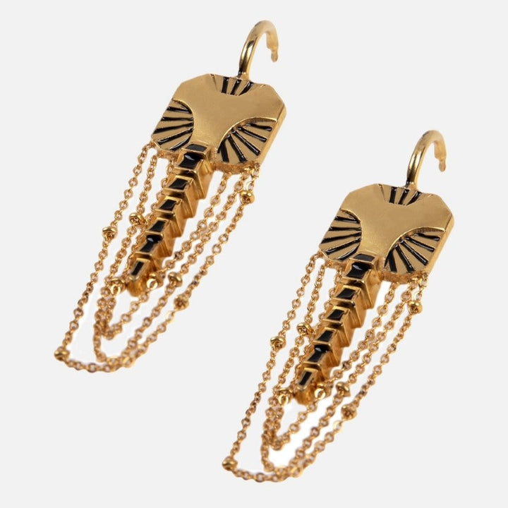 Gold elephant-shaped earrings with black enamel accents and dangling chain details on white background