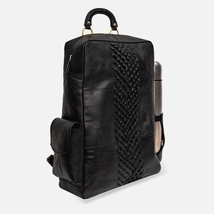 Black leather backpack with braided center detail and side pocket, featuring a handle and metallic water bottle holder