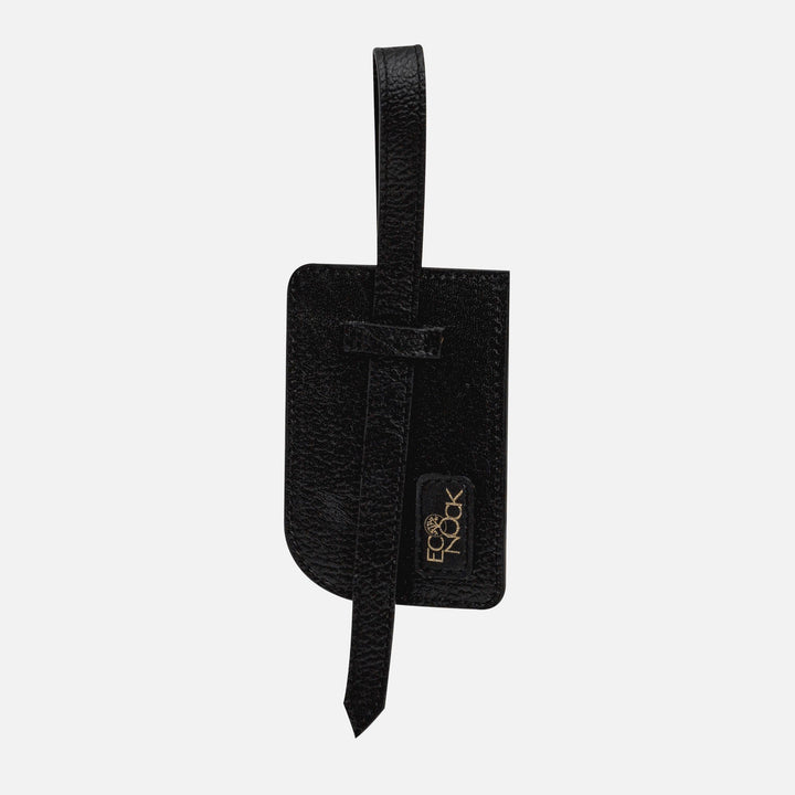 Black textured leather luggage tag with strap and Eco Nook logo on white background
