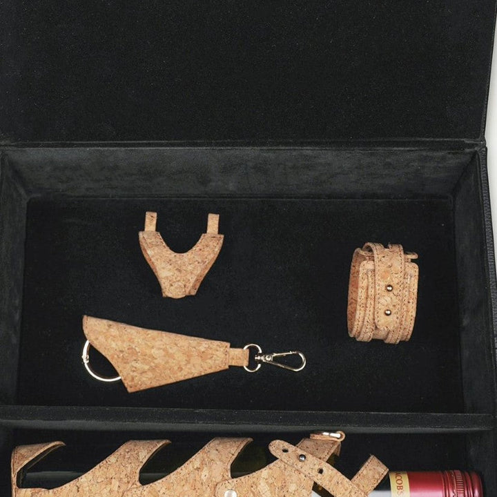 Black gift box containing cork wine bottle holder, cork keychain, cork bracelet, and cork mini bag