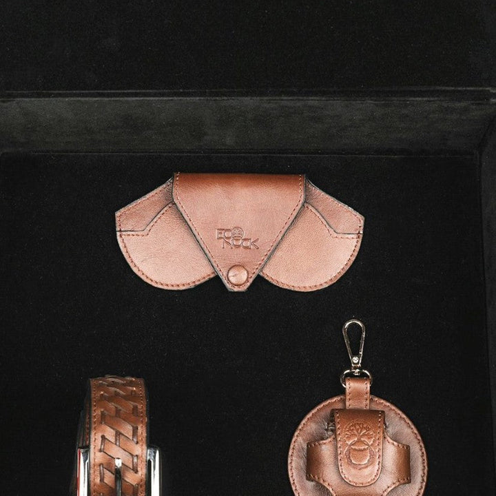 brown leather belt, wallet, and round keychain in black case