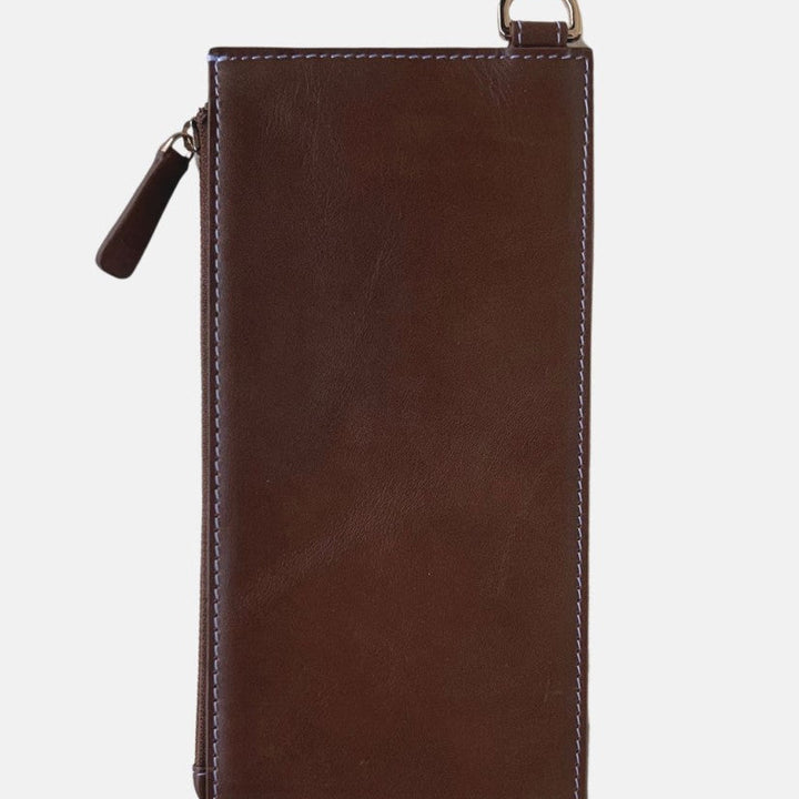 Timeless tan handcrafted leather crossbody bag with white stitching and zipper pull