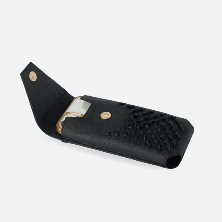 Black upcycled leather iPhone sling with woven detailing and gold snap closure, partially open with phone inside