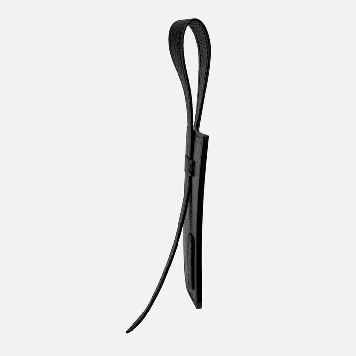 Black leather wrist strap keychain with a loop and textured surface