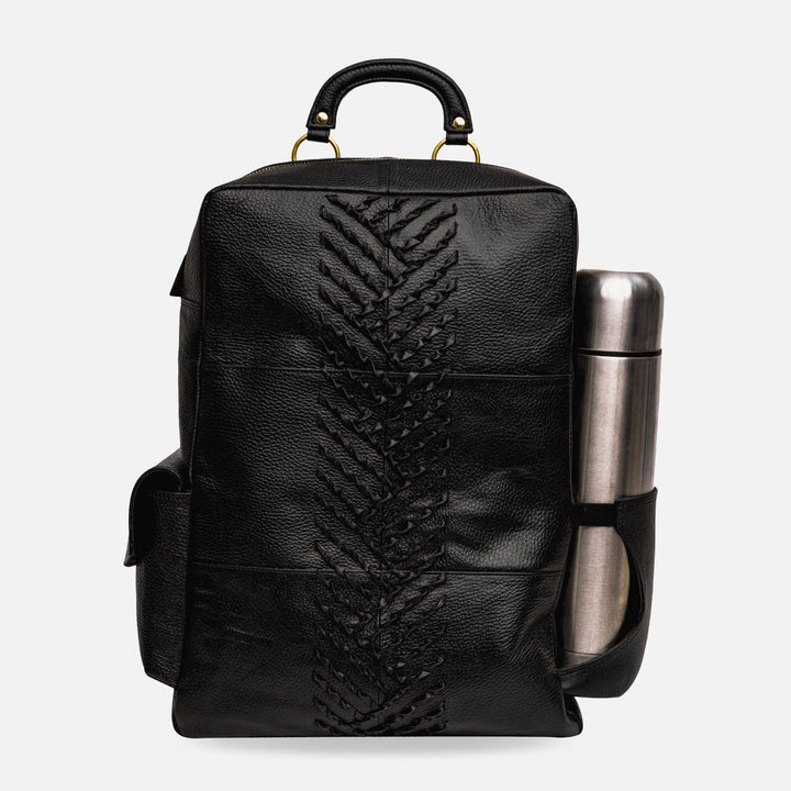 Black leather backpack with braided center design and metal water bottle in side pocket