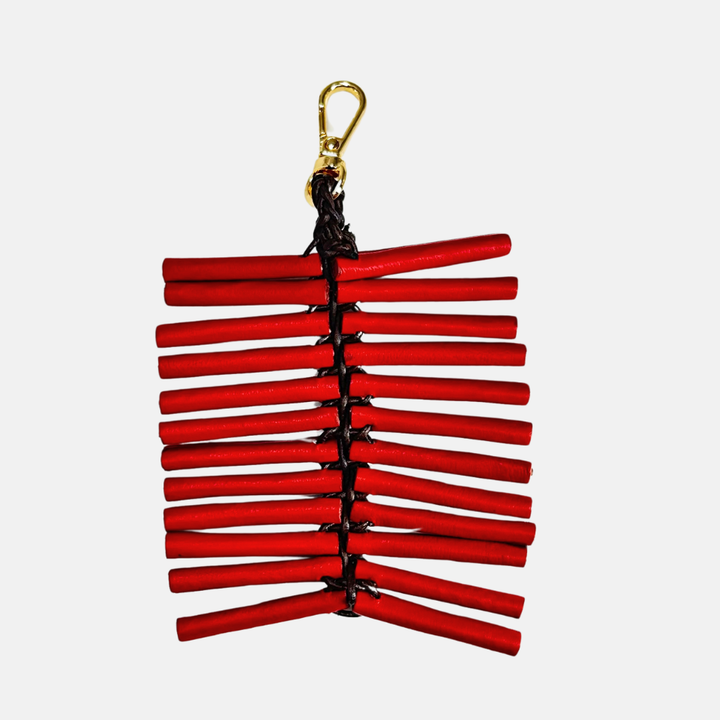 Red firecracker string with gold clasp on white background