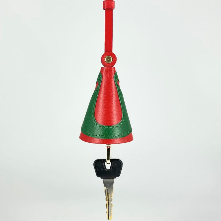 Red and green leather key holder with a hanging strap and a metal key attached