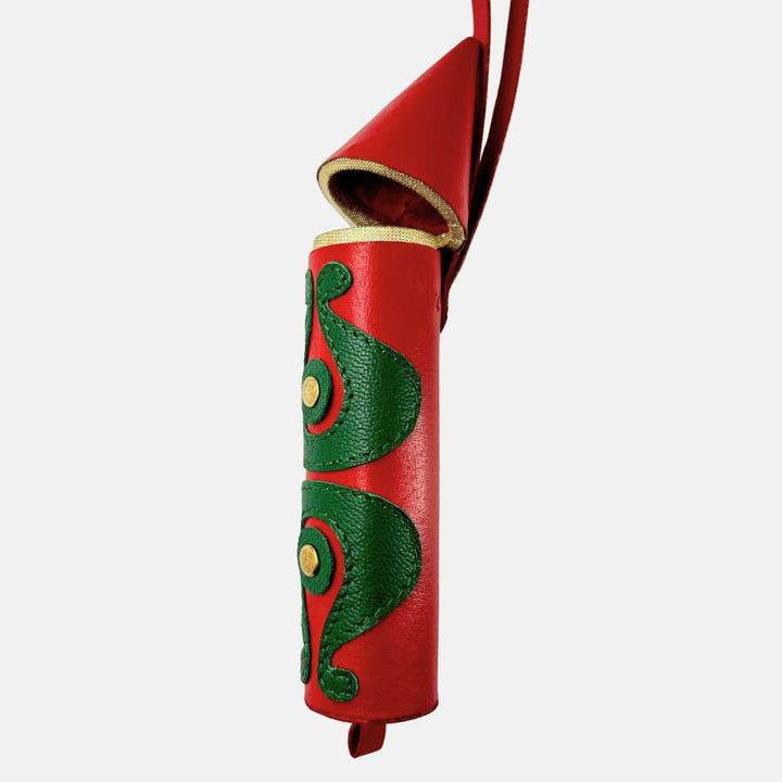 Red leather rocket-shaped hanging charm with green decorative patterns and gold accents